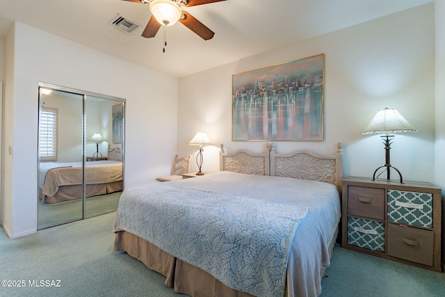 carpeted bedroom with ceiling fan and a closet