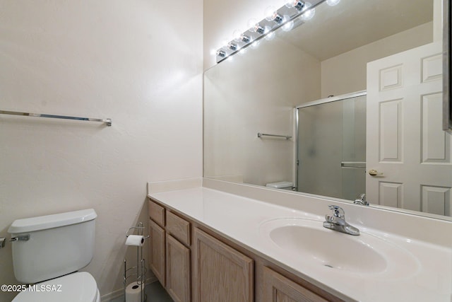 bathroom with vanity, toilet, and walk in shower