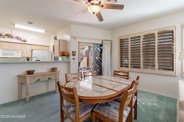 dining area with carpet flooring and ceiling fan