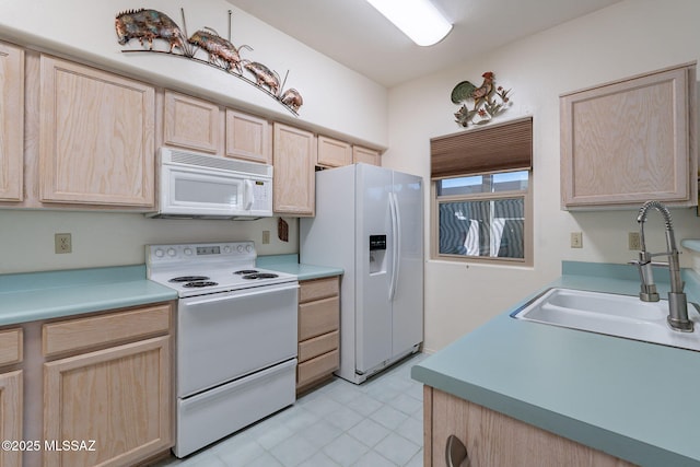 kitchen with light brown cabinets, white appliances, and sink