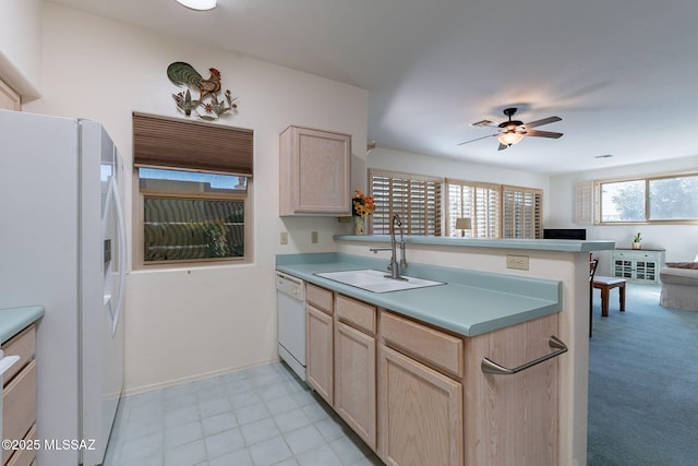 kitchen with kitchen peninsula, light brown cabinetry, white appliances, ceiling fan, and sink