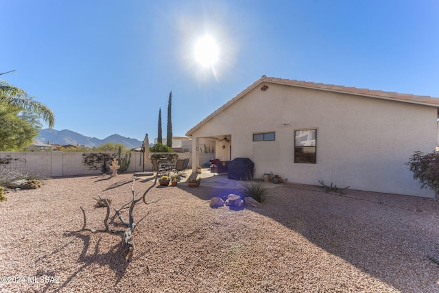 rear view of house with a mountain view and a patio area