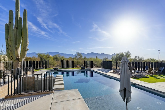 view of pool featuring a mountain view and a patio area