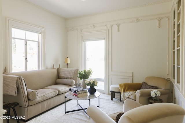 living room featuring a healthy amount of sunlight and ornamental molding