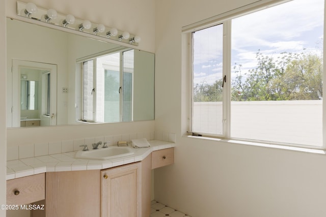 bathroom with tile patterned flooring and vanity