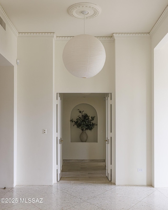 hallway featuring ornamental molding