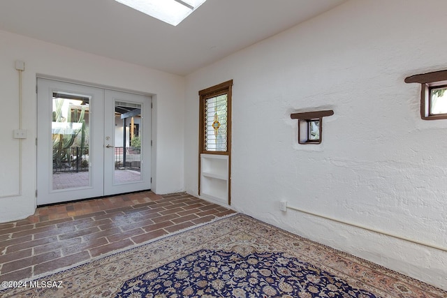 doorway featuring french doors and a skylight