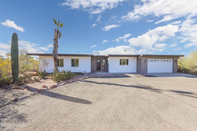 ranch-style home featuring a garage