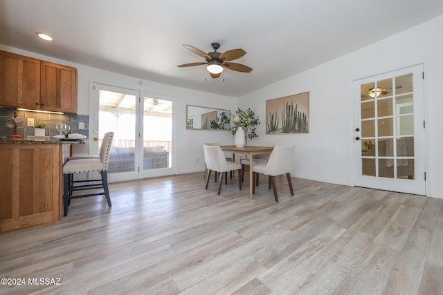 dining room with ceiling fan and light wood-type flooring