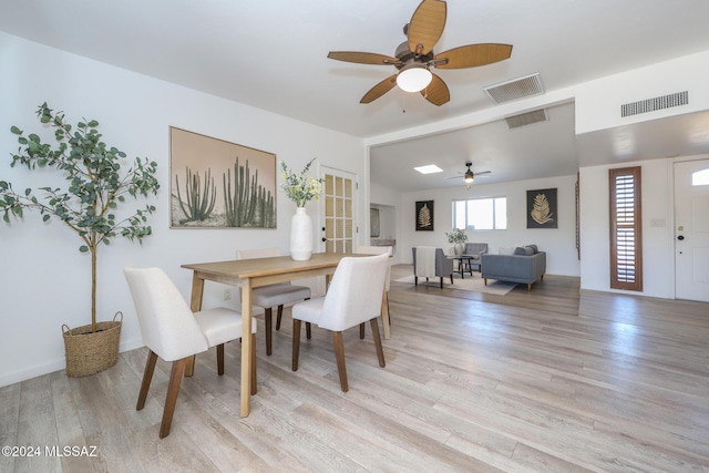 dining room featuring vaulted ceiling, light hardwood / wood-style flooring, and ceiling fan