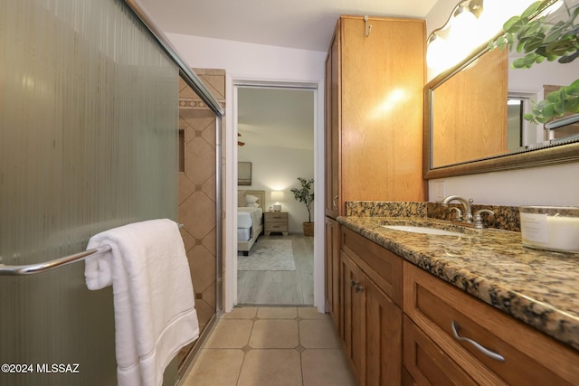 bathroom featuring vanity and a shower with door