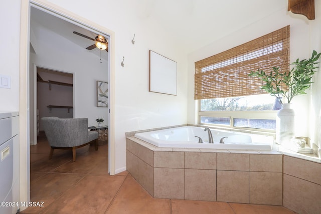 bathroom featuring tile patterned flooring, ceiling fan, and tiled tub