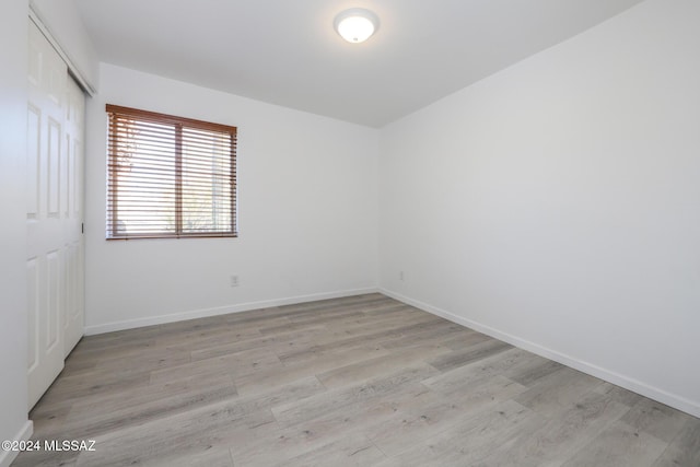 empty room with light hardwood / wood-style flooring