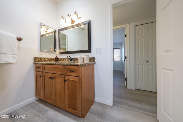 bathroom with vanity and hardwood / wood-style flooring