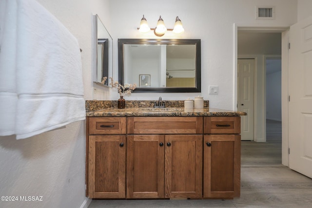 bathroom featuring vanity and hardwood / wood-style flooring