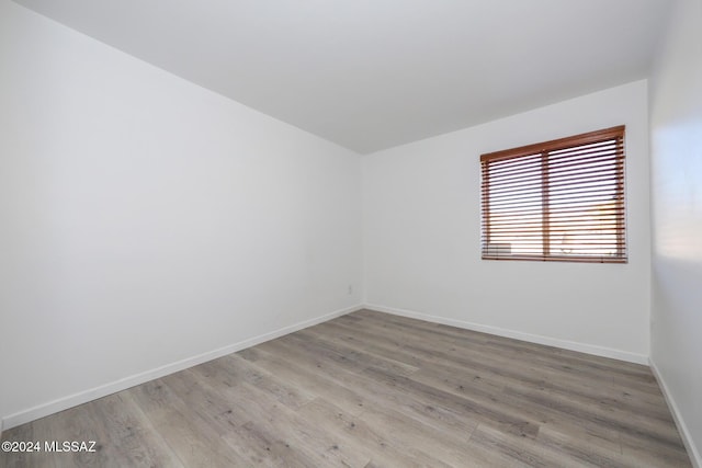 unfurnished room with light wood-type flooring