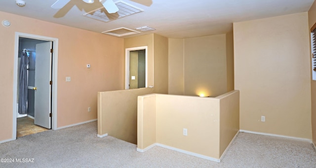 carpeted spare room with ceiling fan