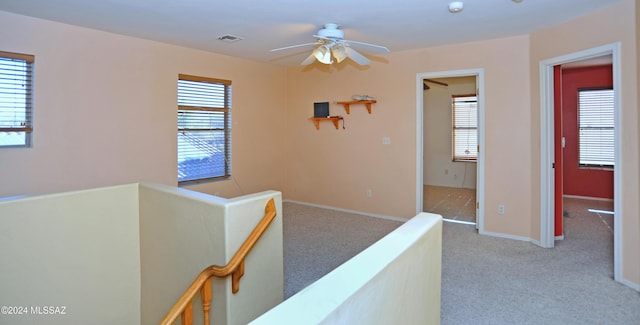 corridor with light colored carpet