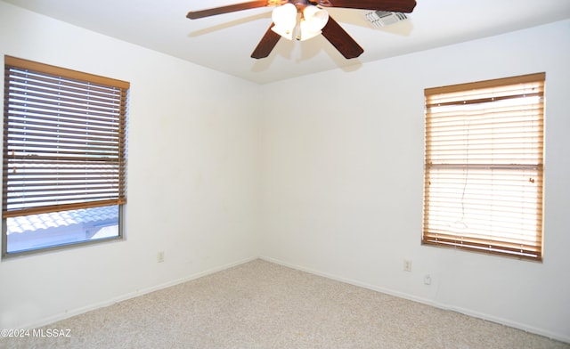 carpeted empty room featuring ceiling fan