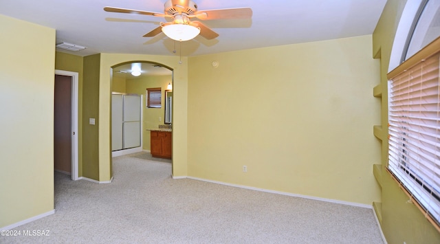 spare room with light carpet and ceiling fan