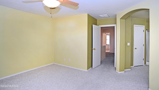 carpeted empty room featuring ceiling fan