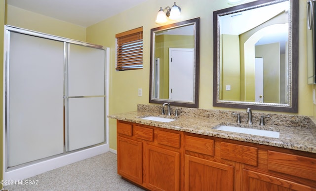 bathroom featuring vanity and a shower with door