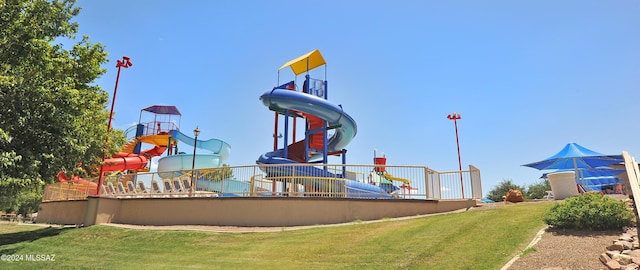 view of playground with a lawn