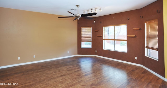 empty room featuring ceiling fan and dark hardwood / wood-style flooring