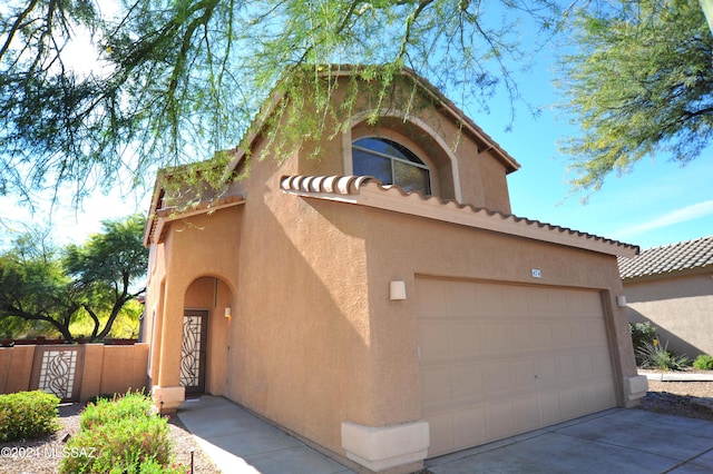 mediterranean / spanish-style home with a garage