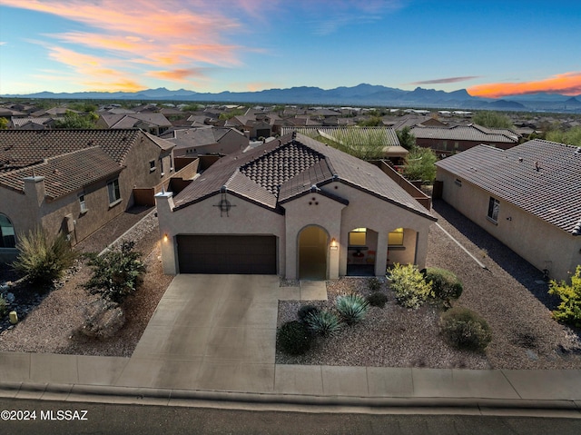 view of front of home with a mountain view and a garage