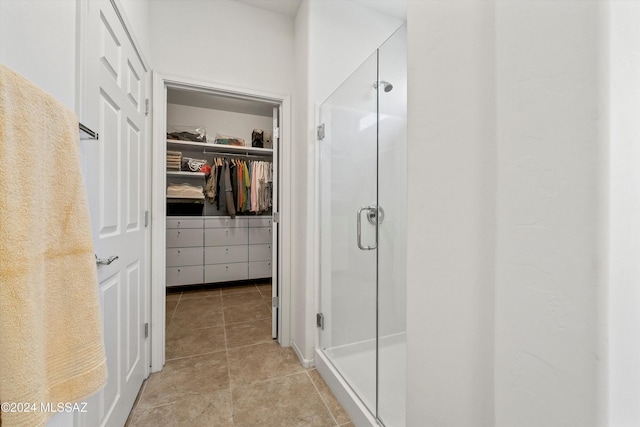 bathroom featuring a shower with shower door