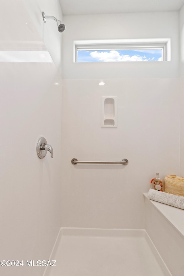 bathroom with walk in shower and a healthy amount of sunlight