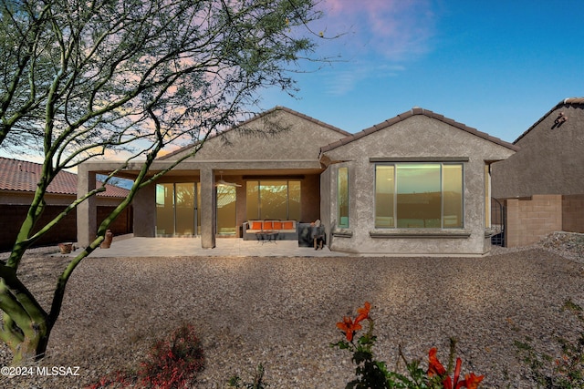 back of property featuring an outdoor living space and a patio area