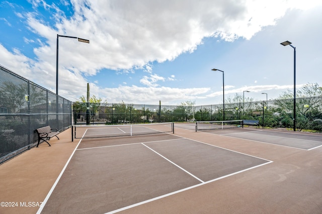 view of tennis court featuring basketball hoop