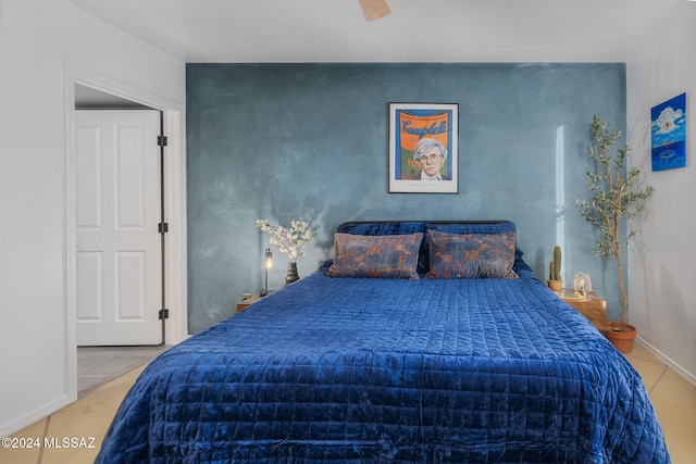 tiled bedroom featuring ceiling fan