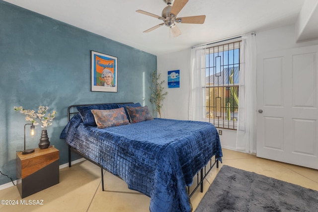 bedroom with light tile patterned floors and ceiling fan