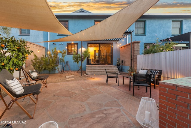 view of patio terrace at dusk