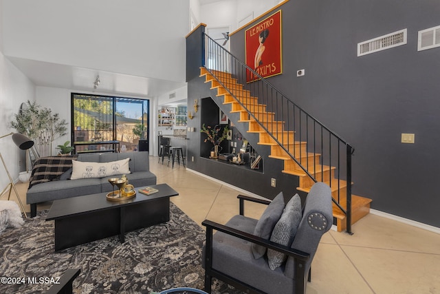 tiled living room featuring an inviting chandelier