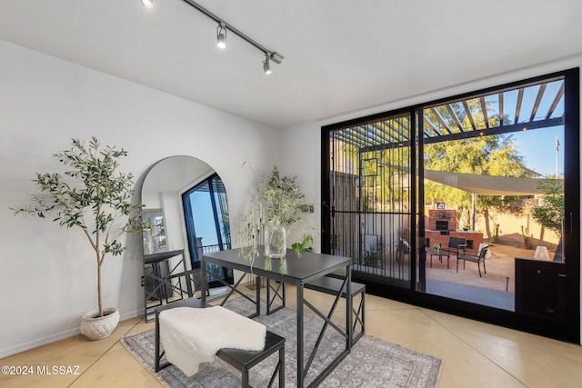 dining space with expansive windows, a wealth of natural light, and light tile patterned floors