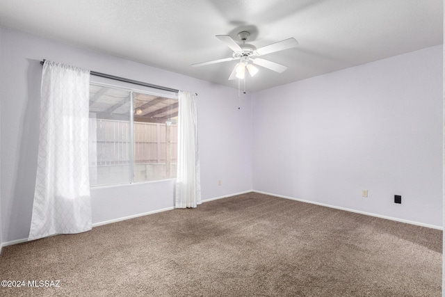 carpeted empty room featuring ceiling fan