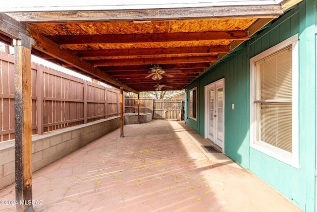 wooden terrace featuring ceiling fan, french doors, and a patio