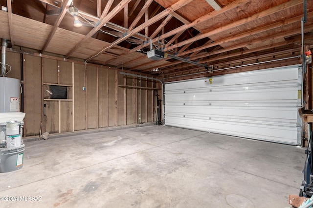 garage with gas water heater and a garage door opener