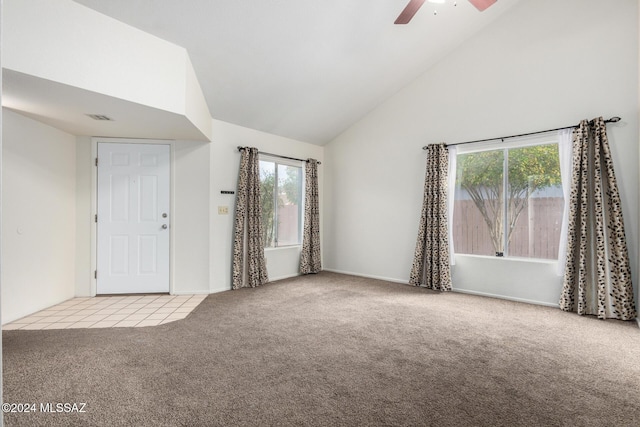 interior space featuring light carpet, high vaulted ceiling, a healthy amount of sunlight, and ceiling fan