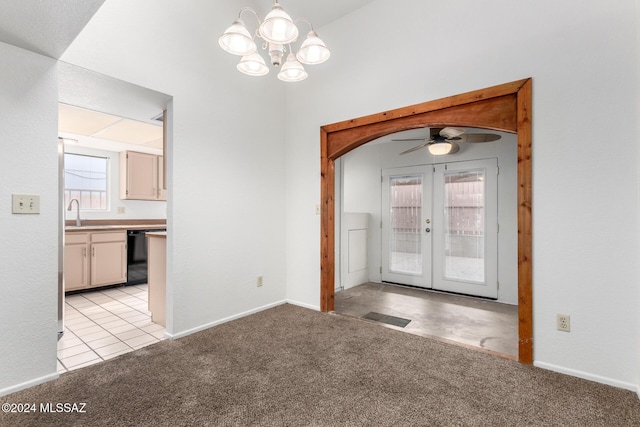 interior space with light carpet, french doors, ceiling fan with notable chandelier, and sink