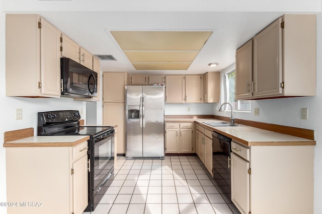 kitchen with light tile patterned flooring, sink, and black appliances