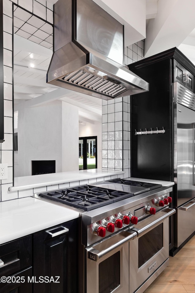 kitchen featuring light hardwood / wood-style floors, stainless steel appliances, and range hood