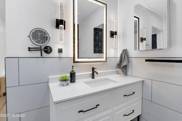 bathroom featuring tile walls and vanity