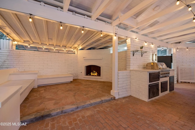 view of patio featuring a fireplace, area for grilling, and exterior kitchen