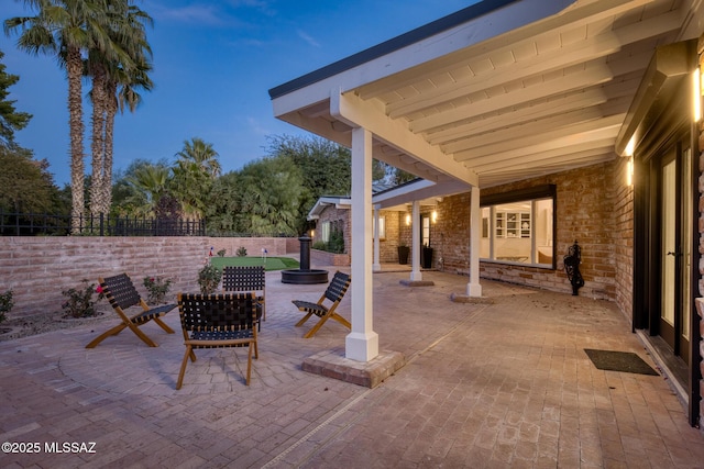 view of patio terrace at dusk