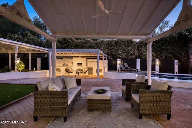 view of patio / terrace featuring ceiling fan and an outdoor living space